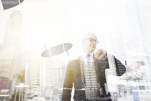 Image of senior businessman checking time on his wristwatch