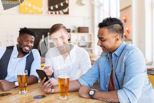 Image of male friends with smartphone drinking beer at bar