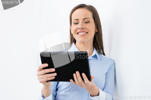 Image of businesswoman with tablet pc working at office