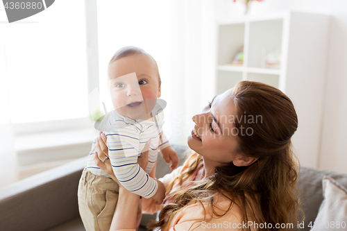 Image of happy young mother with little baby at home