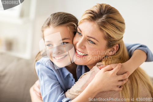 Image of happy smiling family hugging on sofa at home