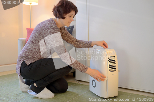 Image of Portable dehumidifier colect water from air