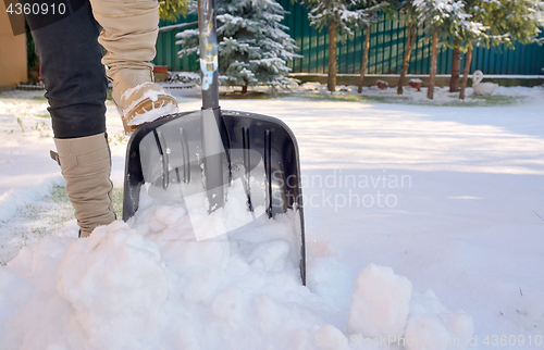 Image of Woman Shoveling her garden