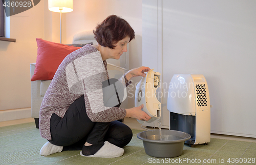 Image of Portable dehumidifier colect water from air