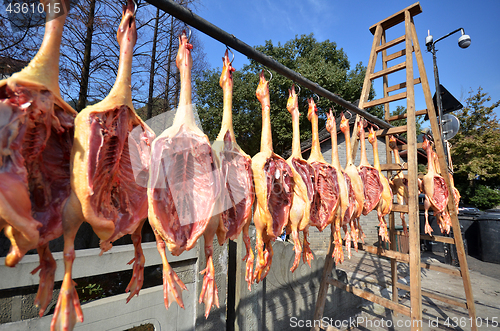 Image of Rows of cured meat hanging to dry