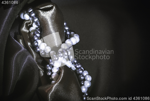 Image of Natural Pearl Necklaces On The Dark Silk Background