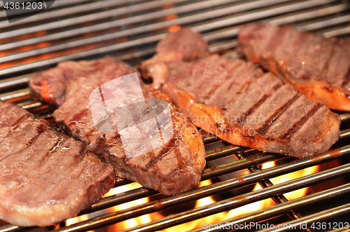 Image of Beef steaks on the grill