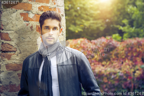 Image of young man in the autumn park