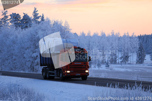 Image of Scania Tipper Hauls Silage Bales at Winter Sunset