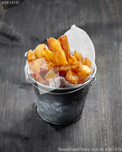 Image of fried potatoes on wooden table