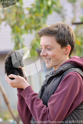 Image of Teenager with a small puppy