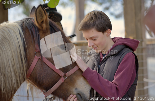 Image of Happy teenager boy with horse