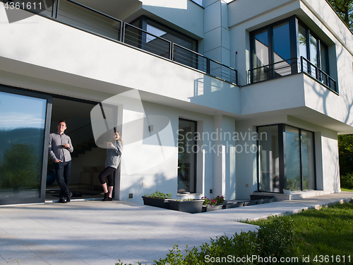 Image of couple enjoying on the door of their luxury home villa