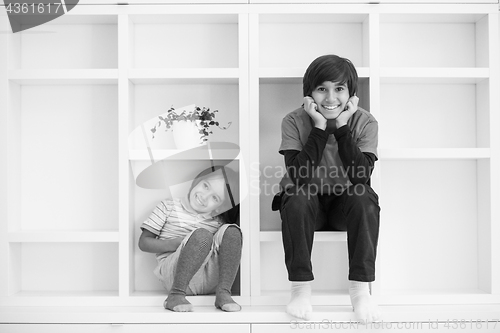 Image of young boys posing on a shelf