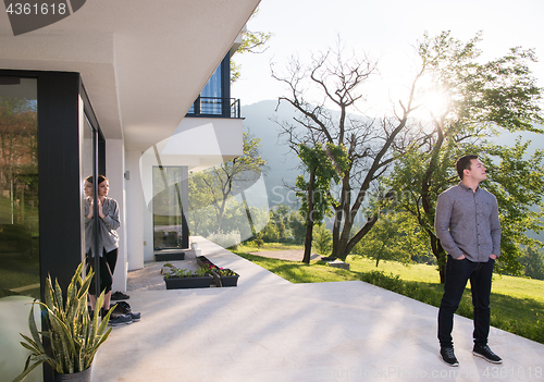 Image of man in front of his luxury home villa