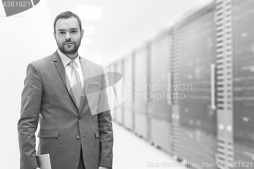 Image of Young businessman in server room