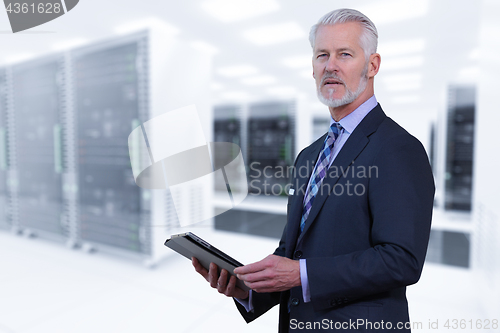 Image of Senior businessman in server room