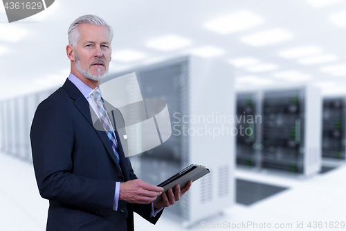 Image of Senior businessman in server room