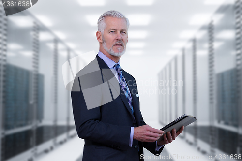 Image of Senior businessman in server room