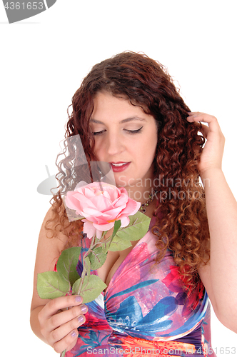 Image of Beautiful woman holding a pink rose