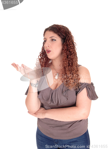 Image of Lovely young woman blowing a kiss