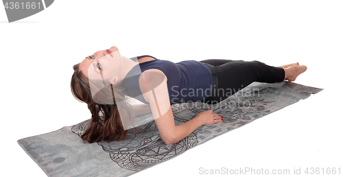 Image of Woman lying on her back lifting up body