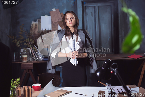 Image of Young business woman throwing documents at camera.