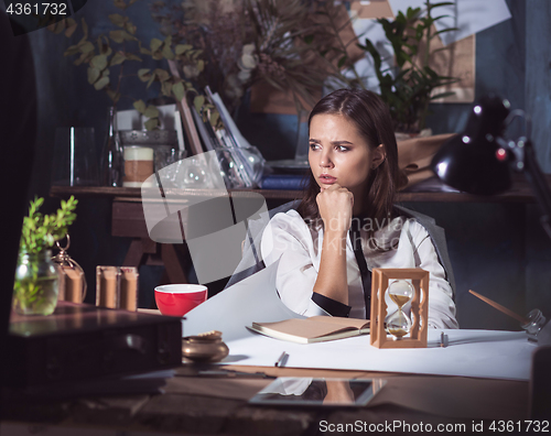 Image of Architect working on drawing table in office