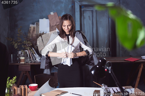 Image of Young business woman throwing documents at camera.