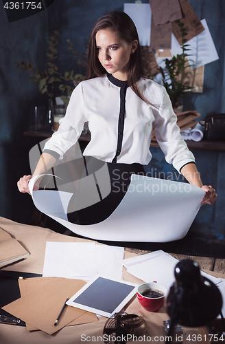 Image of Architect working on drawing table in office