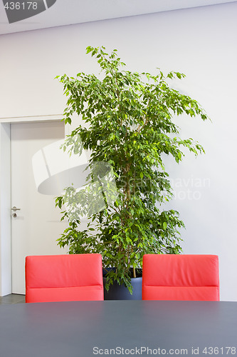 Image of Two red chairs in a meeting room