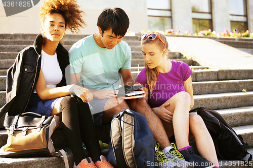 Image of cute group of teenages at the building of university with books huggings, diversity nations