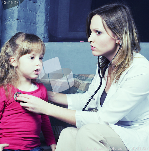 Image of young doctor with little girl patient feeling bad medical inspection