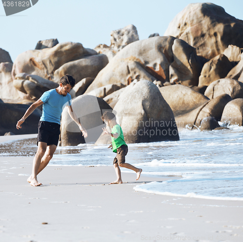 Image of happy family on beach playing, father with son walking sea coast