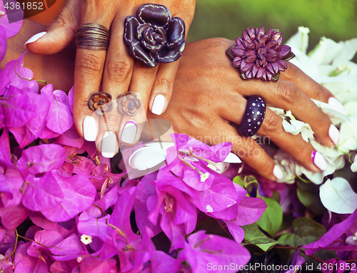 Image of bright colorfull shot of african tanned hands with manicure amon