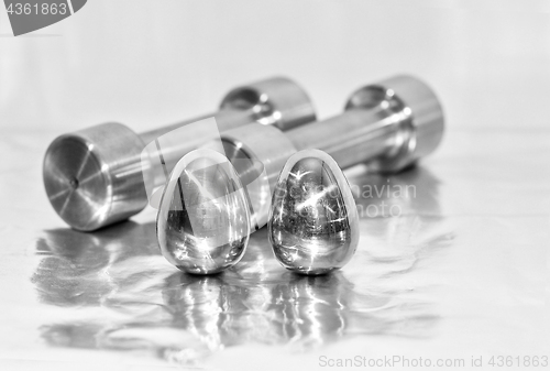 Image of Metal dumbbells and steel eggs, the concept of sports training a