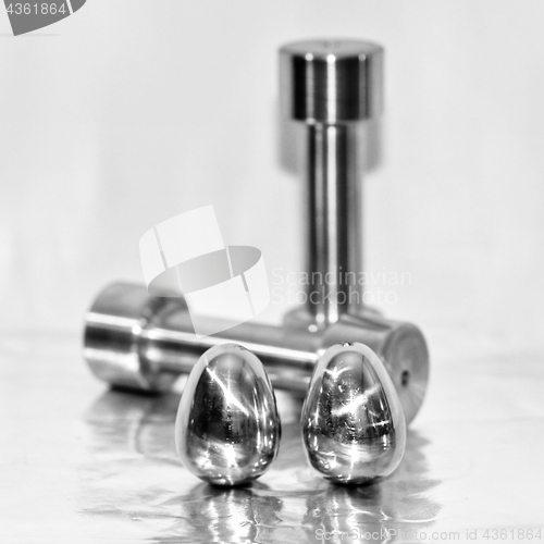 Image of Metal dumbbells and steel eggs, the concept of sports training a