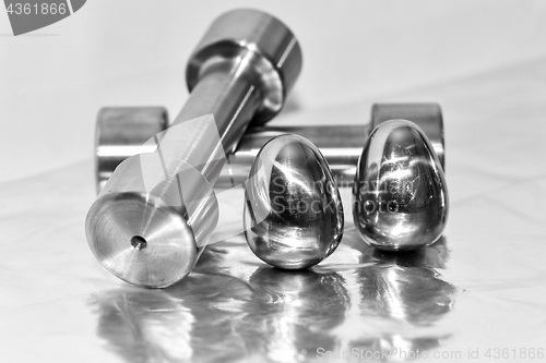 Image of Metal dumbbells and steel eggs, the concept of sports training a