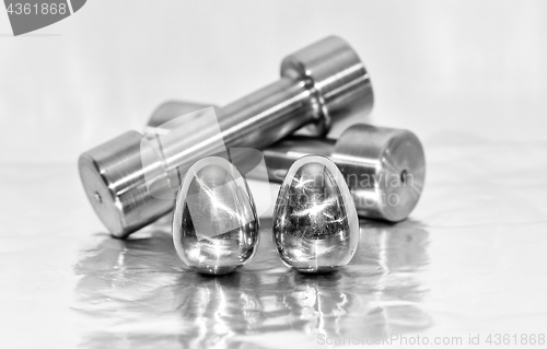 Image of Metal dumbbells and steel eggs, the concept of sports training and the achievement of muscle strength