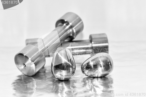 Image of Metal dumbbells and steel eggs, the concept of sports training and the achievement of muscle strength