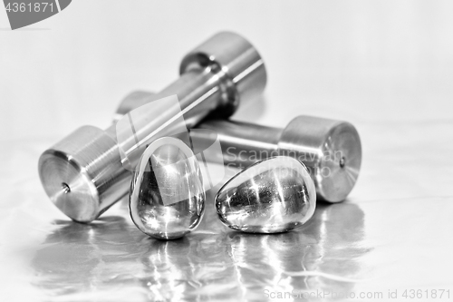 Image of Metal dumbbells and steel eggs, the concept of sports training and the achievement of muscle strength