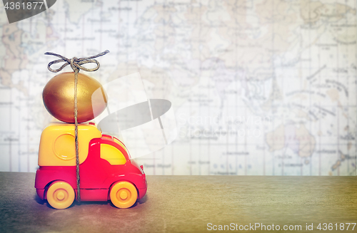 Image of A toy truck carrying a golden egg, a symbol of the reliability of delivery of postal goods
