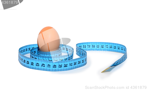 Image of Egg wrapped in blue measuring tape, slimming concept