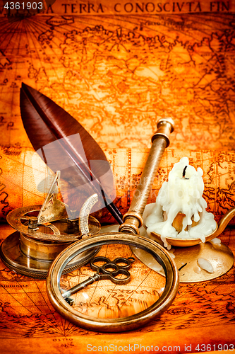 Image of Vintage still life. Vintage items on ancient map.