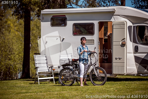 Image of Woman on electric bike resting at the campsite VR Caravan car Va