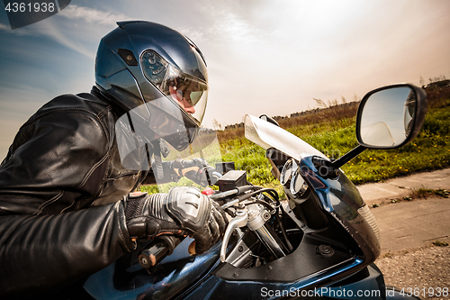 Image of Biker racing on the road