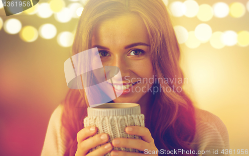 Image of close up of woman with tea or coffee cup at home