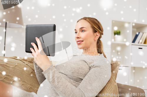 Image of smiling woman with tablet pc at home