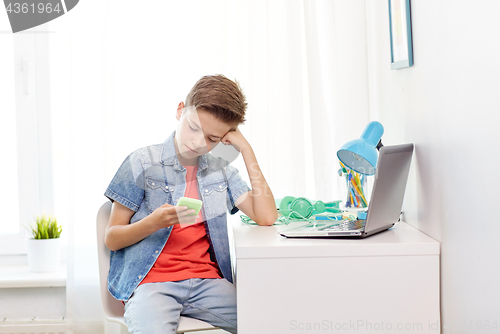 Image of boy with smartphone being bullied by text message