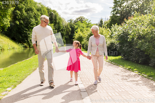 Image of senior grandparents and granddaughter at park